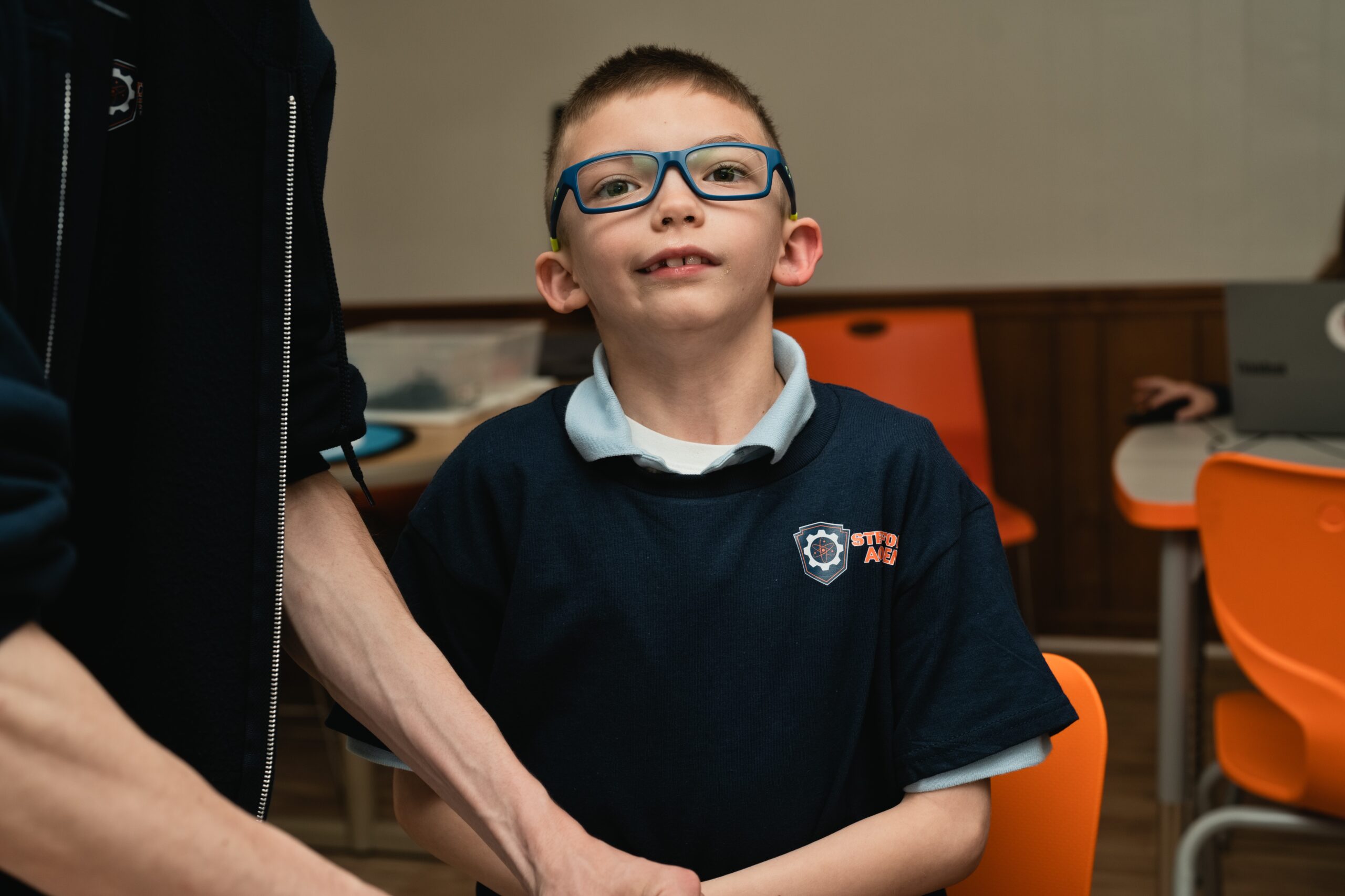 STEMForce student building a robot at The Academy